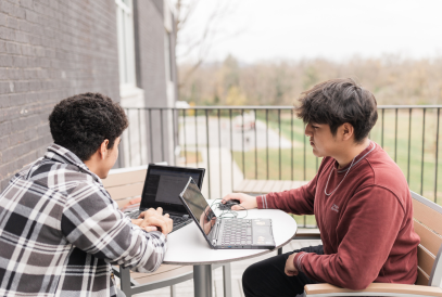  two students working together on their computers