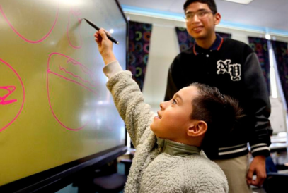  student teacher working with Quarles elementary student