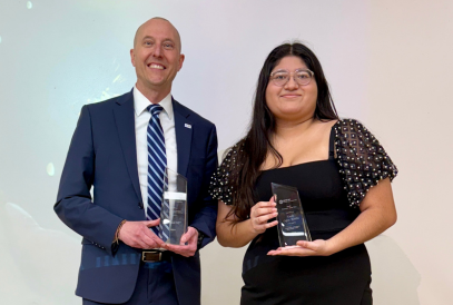  two people holding awards