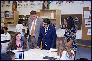 Secretary of Education Atif Qarni listens to student 