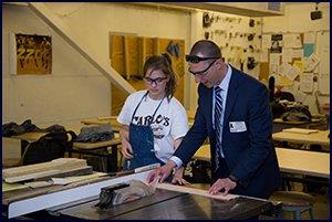 Superintendent Jason Van Heukelum works with CTE student 