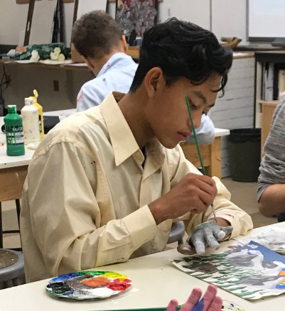 Student painting hand  